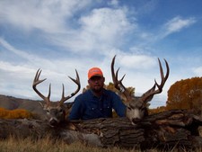 Ty Jarvis pictured here with two nice deer taken during the fall 2006 hunting season.  The whitetail on the left was taken along the Laramie River, while the mule deer was taken few miles south of the ranch headquarters.